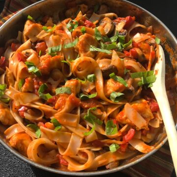 Chicken Tomato Pasta with Red Peppers & Mushrooms a one-skillet wonder with creamy, tangy and sweet tomatoes and peppers, earthy mushrooms, hearty chicken, nutty parmesan cheese and fresh basil. Made with gluten free pasta, it's a gluten free dish too!