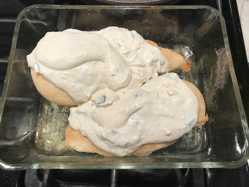 Creamy Garlic Parmesan Chicken in casserole dish before being baked and browned.