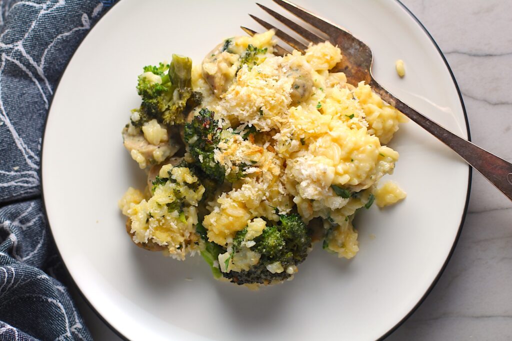 Cheesy Chicken and Broccoli Rice Casserole with bread crumb topping on a plate with fork.