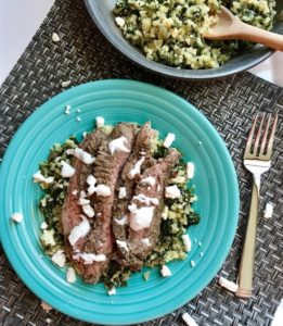 Mediterranean Flank Steak with Kale & Feta Cauliflower Rice is a delicious Mediterranean-inspired recipe with a flavorful garlic-oregano-rubbed flank steak on top of delicious cauliflower “rice”. To finish it off, a cool and bright Lemon & Garlic Yogurt Sauce.