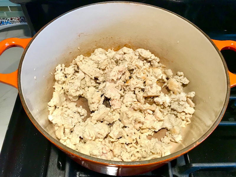 Ground chicken in pot for this Creamy Tomato Soup with Ground Chicken and Spinach is creamy and chunky and has a ton of deep flavor. AND it is healthy! It uses all white meat ground chicken that you cook until it is incredibly browned for some serious flavor. Then tomato paste adds the flavor back drop for the soup and a flour roux plus broth creates the amazing creaminess! Finally Spinach is your veggie boost.