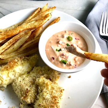 Remoulade sauce in bowl on plate with fish and chips