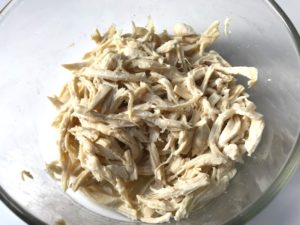 Shredded Chicken in bowl for Chicken Tortilla Soup. It's quick, it's easy, it's delicious AND...it's an all-in-one balanced dish because I have added KALE! Done in 30 minutes!