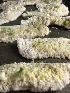 Raw chicken breaded on pan