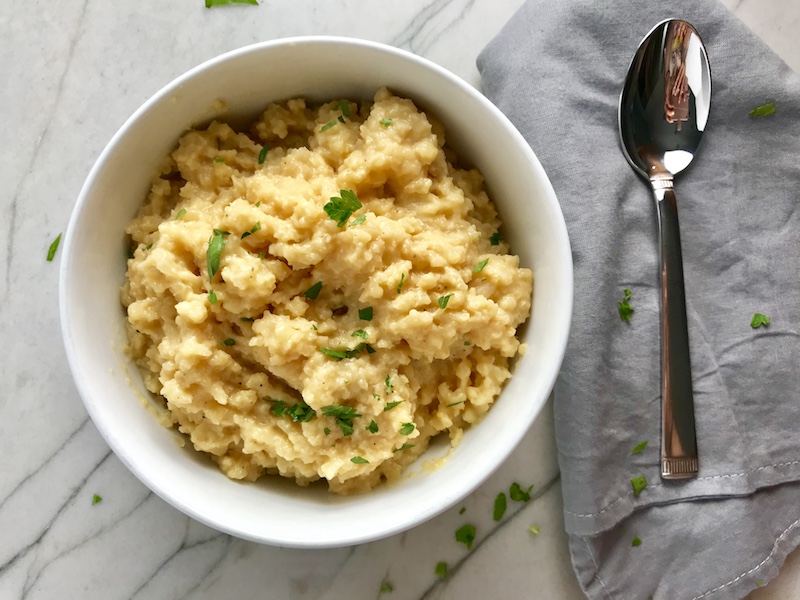 Welcome to my new favorite comfort food with a healthy twist: Cheesy Cauliflower Rice. If Mac and Cheese met Cauliflower, fell in love and had a baby, it would be this Cheesy Cauliflower Rice. This recipe is so simple with just the flavors from the cauliflower - plus a few other things to help it come together.