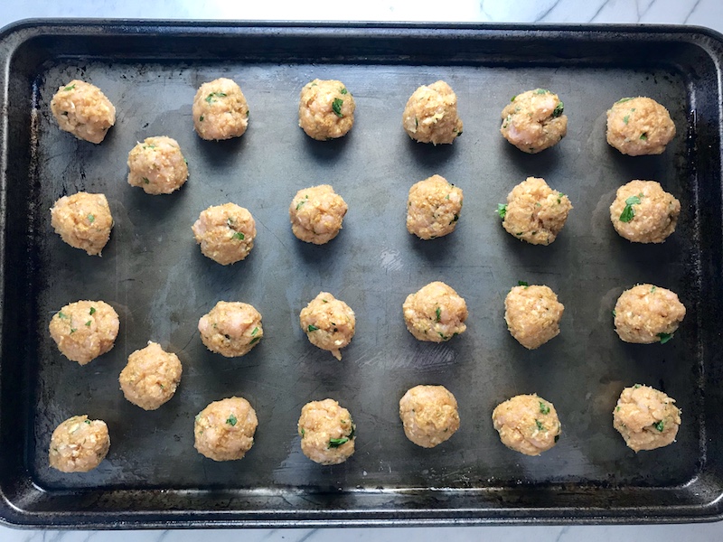Raw Moroccan raw turkey meatballs on a sheet pan to go into Pita Bread Sandwiches Recipe.