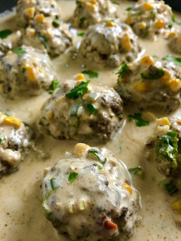 Chipotle Meatballs with Mexican Corn Cream Sauce are delicious! The meatballs are made with lean ground beef, black beans, chipotle peppers in adobo sauce, ground tortilla chips, and scallion and then baked to perfection. The creamy sauce is inspired by Mexican Street Corn with sweet corn, smoky Mexican spices, cool and tangy sour cream. Yum!