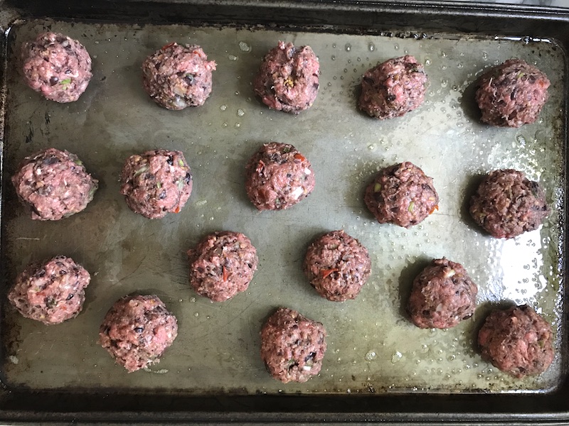 Raw meatballs on a pan for Chipotle Meatballs with Mexican Corn Cream Sauce