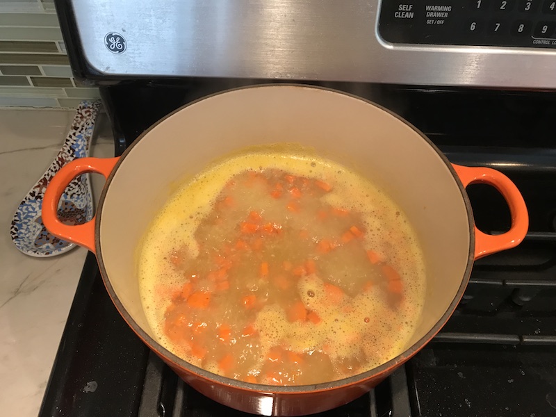 5-Ingredient Chunky Chicken Vegetable Soup in a bowl on counter with spoon in bowl. It's creamy (but there is no dairy!) and chunky, and delicious! With loads of chicken, carrots, and peas.