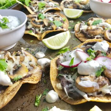Mushroom and Black Bean Tostadas with Manchego Cheese, and Cilantro Lime Cream are crazy good! The tortillas are baked until crunchy, then topped with homemade refried black beans, nutty aged Manchego Cheese, sautéed mushrooms, and then baked until the cheese is melted. Top with cool cilantro lime cream, crisp radishes, and fresh cilantro. Simple, Gluten-Free, Vegetarian, Delicious!