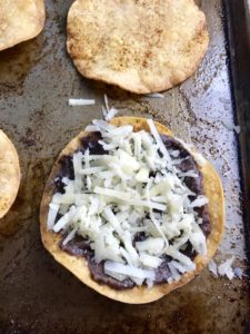 Mushroom and Black Bean Tostadas with Manchego Cheese, and Cilantro Lime Cream are crazy good! The tortillas are baked until crunchy, then topped with homemade refried black beans, nutty aged Manchego Cheese, sautéed mushrooms, and then baked until the cheese is melted. Top with cool cilantro lime cream, crisp radishes, and fresh cilantro. Simple, Gluten-Free, Vegetarian, Delicious!
