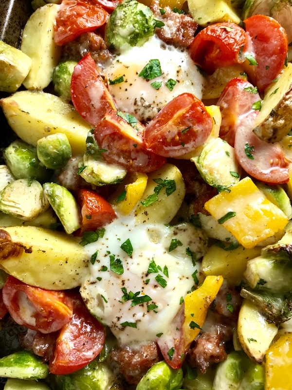 This One Pan Egg, Potato, Sausage Recipe is LOADED with flavors and textures. You get the salty Italian Sausage, sweet bell pepper, creamy potatoes, sweet and juicy tomatoes, meaty brussel sprouts, creamy eggs, and salty, nutty cheddar cheese. Best of all, the entire meal cooks on one large pan!