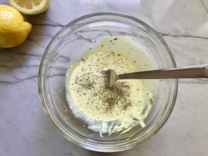 In a small bowl, add the sour cream, lemon zest, juice from half of the lemon, honey, yellow mustard, parsley.