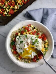 This 5-ingredient Sunny Quinoa with Fried Egg & Veggie Medley is simple, but incredible. The Veggie Medley is a trifecta of red pepper, zucchini, and sweet corn that are roasted on a sheet pan. Then on top of it all is a salty fried egg with a runny yoke that oozes out to bring a deep creaminess to the entire dish.