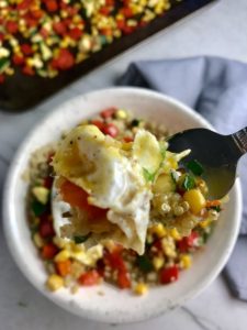 This 5-ingredient Sunny Quinoa with Fried Egg & Veggie Medley is simple, but incredible. The Veggie Medley is a trifecta of red pepper, zucchini, and sweet corn that are roasted on a sheet pan. Then on top of it all is a salty fried egg with a runny yoke that oozes out to bring a deep creaminess to the entire dish.