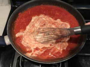 Luscious Tomato Cream Sauce Pasta mixing in the sour cream.