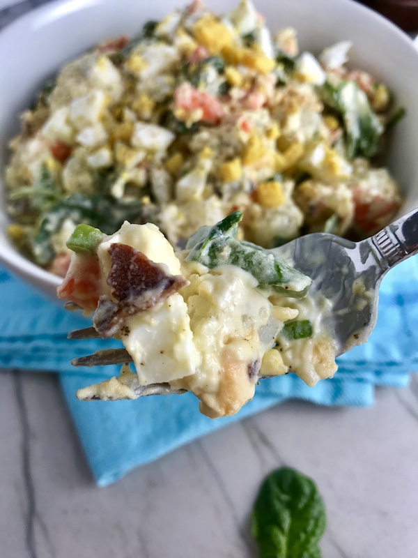 This Fully Loaded Potato Salad has salty bacon and cheddar cheese, creamy and rich egg, fresh scallions and baby spinach, and crunchy carrots. The dressing is simple with a blend of yellow mustard and mayo. Make ahead and enjoy later! YUMM-Y!