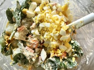 This Fully Loaded Potato Salad has salty bacon and cheddar cheese, creamy and rich egg, fresh scallions and baby spinach, and crunchy carrots. The dressing is simple with a blend of yellow mustard and mayo. Make ahead and enjoy later! YUMM-Y!