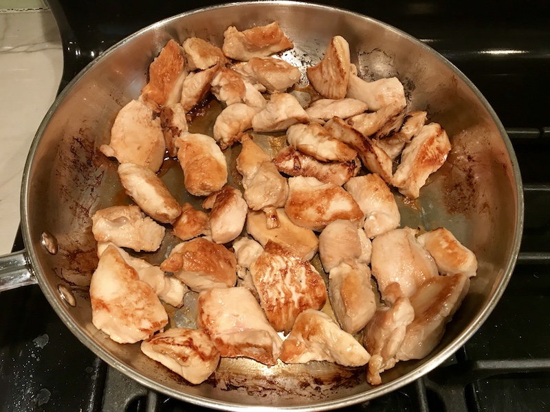 Chicken cooking in pan for Peanut Teriyaki Chicken and Broccoli stir fry with rice noodles.