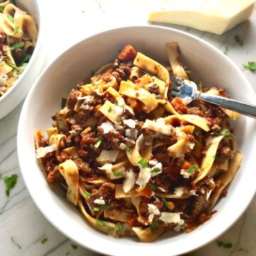 Anniversary Slow Cooker Beef Bolognese is a souped-up version of the traditional Italian Meat Sauce made EASY in the slow cooker! The flavors of the ingredients with the meat become one and turn into this amazing thick sauce. I add even MORE FLAVOR with Pancetta and Demi-Glace. Delicious!