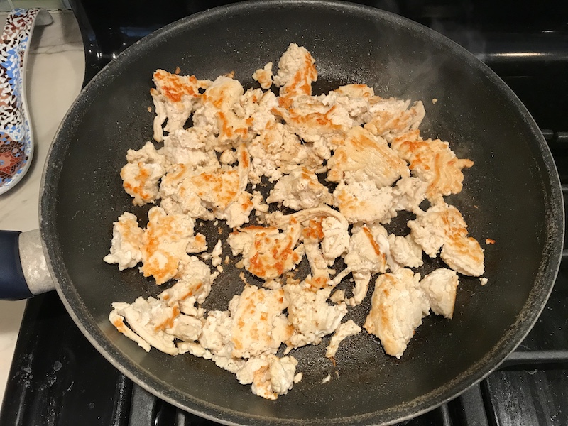 This Skillet Ground Chicken Tomato Sauce with Ricotta is a delicious and simple one pan meal. Ground chicken is seared until it gets a super browned, flavorful crust. Then garlic, vegetable broth and tomatoes are added and cooked down into a delightful sauce that really lets the tomato shine with a meaty bite from the chicken. After pasta is mixed in, creamy Ricotta Cheese is dolloped on and fresh basil added to garnish. It's perfection! Bellissimo!