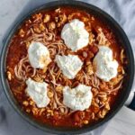 Tomato Chicken Ricotta Pasta in a skillet on counter.