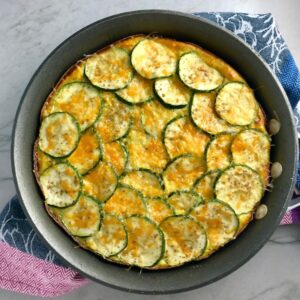 Vegetable Frittata with Lemon Crema is an easy weeknight dinner, quick breakfast, or weekend brunch recipe! This Vegetable Frittata is thick and hearty with lots of flavors and textures from the veggies, but is also light and creamy from the eggs and cheese. It's loaded with healthy veggies, is gluten free, and super EASY to make and to clean up after.