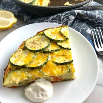 Vegetable Frittata with Lemon Crema is an easy weeknight dinner, quick breakfast, or weekend brunch recipe! This Vegetable Frittata is thick and hearty with lots of flavors and textures from the veggies, but is also light and creamy from the eggs and cheese. It's loaded with healthy veggies, is gluten free, and super EASY to make and to clean up after.