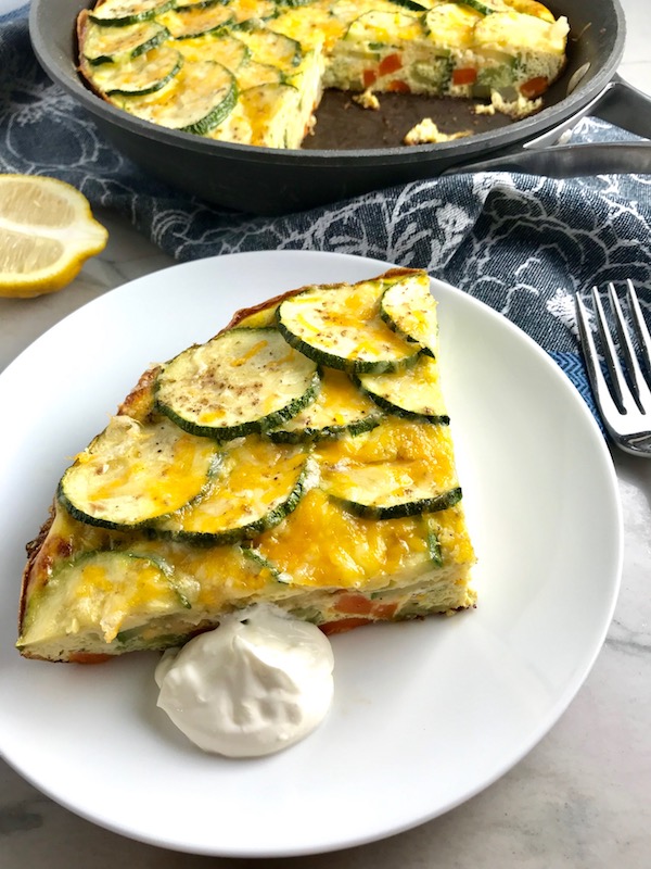 Vegetable Frittata with Lemon Crema is an easy weeknight dinner, quick breakfast, or weekend brunch recipe! This Vegetable Frittata is thick and hearty with lots of flavors and textures from the veggies, but is also light and creamy from the eggs and cheese. It's loaded with healthy veggies, is gluten free, and super EASY to make and to clean up after.