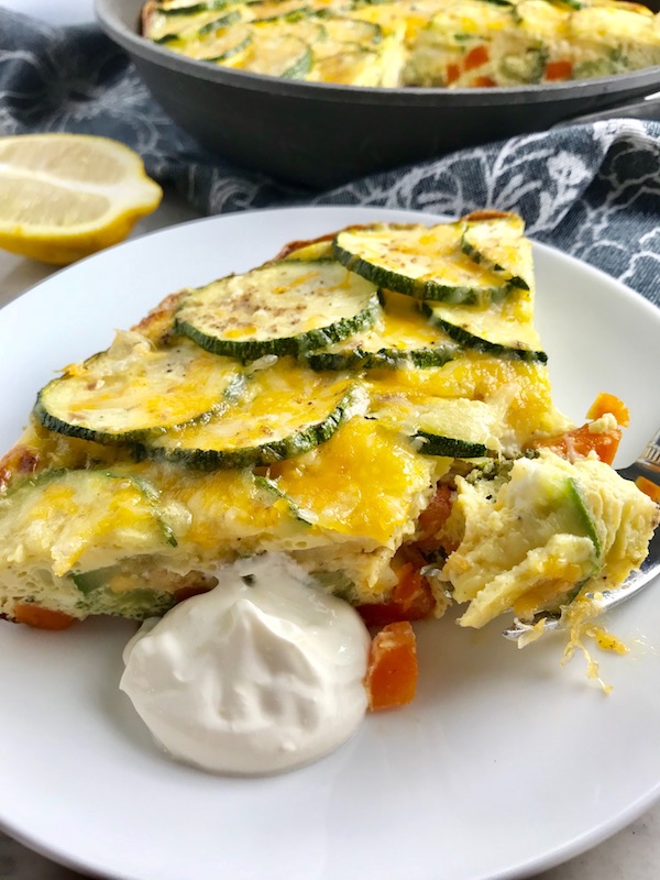 Vegetable Frittata with Lemon Crema is an easy weeknight dinner, quick breakfast, or weekend brunch recipe! This Vegetable Frittata is thick and hearty with lots of flavors and textures from the veggies, but is also light and creamy from the eggs and cheese. It's loaded with healthy veggies, is gluten free, and super EASY to make and to clean up after.