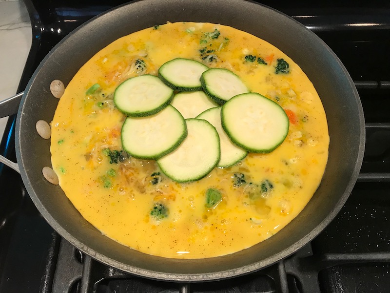 Vegetable Frittata with Lemon Crema is an easy weeknight dinner, quick breakfast, or weekend brunch recipe! This Vegetable Frittata is thick and hearty with lots of flavors and textures from the veggies, but is also light and creamy from the eggs and cheese. It's loaded with healthy veggies, is gluten free, and super EASY to make and to clean up after.