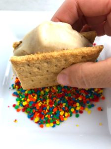 Dipping a banana and graham cracker ice cream sandwich into rainbow sprinkles. Banana Ice Cream is literally just 2 ingredients, Frozen Bananas and Almond Milk. Add in crunchy Graham Crackers as the 3rd ingredient and you have a delicious healthy Banana Ice Cream Sandwich! If you have never tried banana ice cream, you are in for a treat! It tastes just like soft serve ice cream.