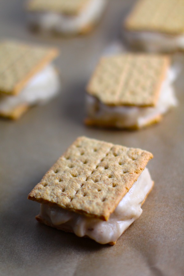Close Up of Banana Ice Cream sandwich from side view with graham cracker top. Banana Ice Cream is literally just 2 ingredients, Frozen Bananas and Almond Milk. Add in crunchy Graham Crackers as the 3rd ingredient and you have a delicious healthy Banana Ice Cream Sandwich! If you have never tried banana ice cream, you are in for a treat! It tastes just like soft serve ice cream.