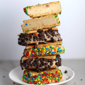 Banana almond milk Ice Cream Sandwiches with Sprinkles and chocolate chips stacked on top of each other.