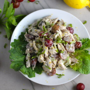 Chicken and Grapes Salad with Lemon Basil Dressing on a white plate on counter with basil, grapes, and lemon on counter. Recipe is simple, but let me tell you, the taste is anything but simple. This Chicken & Grape salad has so much depth with layers of flavors and textures. You get the hearty texture from the chicken, brightness from the lemon, the fresh and fragrant basil, a slight bite from the onion, and a huge juicy burst of sweetness from the grapes....so yummy!