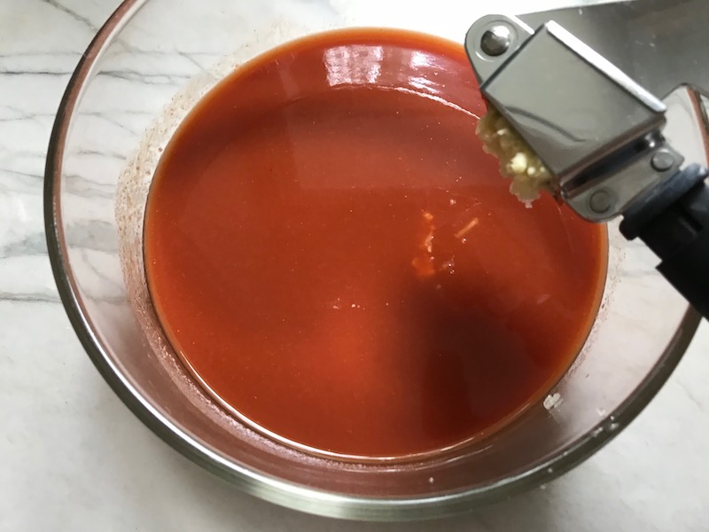 This Roast Red Pepper Gazpacho recipe is Summer in a bowl. It's cool, tangy, crunchy, fresh, and creamy. The base is tomato, but this Gazpacho recipe puts Roast Red Pepper in the starring role, which brings another layer of creamy sweetness. Then you get the crunch from the green pepper, cucumber, garlic and scallions.