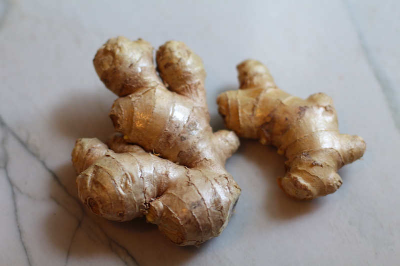 Whole ginger root on counter for Korean Rice Bowl with Lentils and Cauliflower recipe, which is da bomb, exploding with flavor! The rice soaks up the sauce, which gives you a nutty, salty flavor from sesame oil and soy sauce, a warm and zesty kick from ginger and garlic, and sweetness from honey to balance it all out. Lentils and cauliflower give a meaty bite.