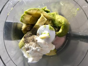 Avocado pieces, sour cream, salt, pepper, and lime juice in food processor for Avocado Crema to go with Roasted Carrot Fries.