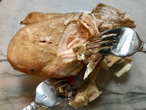 cooked chicken breast being shredded with 2 forks. This Slow Cooker Chicken and Mushroom Soup is warm, hearty, comforting, earthy, and just devine. The mix of blended and chunky mushrooms with carrots, onions, celery, shredded chicken, and herbs gives you a perfect bite every time.