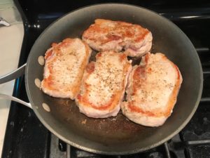 4 Seared pork chops in skillet. Smothered Pork Chop Casserole is a true midwestern comfort dish with layers of vegetables and meaty pork chops smothered in a creamy sauce and cheese. The pork chops in this delicious casserole are left whole so that you get an entire portion dripping in goodness in one scoop.