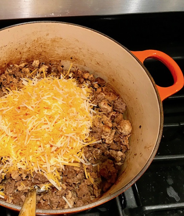 Chicken, Beef, and shredded cheese added to pot. These Hanky Panky Canapes are the BEST Party Appetizers around! They cheesy, meaty, and absolutely delicious. Ground Beef is mixed with Homemade Chicken Sausage and then combined with lots of cheese until its a creamy addictive pot of goodness. Then it is scooped on top of bread, toasts, or crackers
