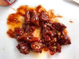 Chopped chipotle peppers in adobo sauce on cutting board next to can for Chipotle Chicken Enchilada Stew. It is one of my Prepped Freezer Meal recipes and it's creamy, cozy, hearty, cheesy, and slightly spicy. All ingredients freeze raw, thaw, then cook in the slow cooker or in the oven. It's a stew because it's thick and hearty with bites of chicken, carrots, onion, chipotle peppers, cumin, garlic and tortilla chips that melt down to thicken this delicious stew.