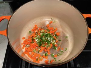 Diced carrots and scallions in pot for Stove top Easy Tuna Casserole. This is a creamy and delicious comfort dish with tuna and noodles and a surprise pop of sweet from Pimiento. This easy recipe is completely from scratch (no canned soup here!) but I can promise you it's so easy and only takes 30 minutes because it's a Casserole that you can make entirely on the stove top!