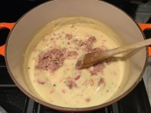 tuna added to sauce for Cheesy Tuna Noodle Casserole Recipe. It's a creamy and delicious comfort dish with tuna and noodles and a surprise pop of sweet from Pimiento. This easy recipe is completely from scratch (no canned soup here!) but I can promise you it's so easy and only takes 30 minutes because it's a Casserole that you can make entirely on the stove top!