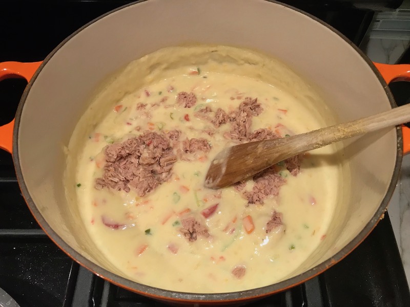 tuna added to sauce for Cheesy Tuna Noodle Casserole Recipe. It's a creamy and delicious comfort dish with tuna and noodles and a surprise pop of sweet from Pimiento. This easy recipe is completely from scratch (no canned soup here!) but I can promise you it's so easy and only takes 30 minutes because it's a Casserole that you can make entirely on the stove top!