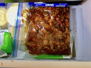 All raw ingredients in freezer bag in freezer for Freezer Hoisin Chicken with Red Peppers, Carrots, Onions, Ginger, and Soy sauce is delicious and so easy to make. You get sweet and savory all in one dish and it's perfect for kids because it's sweet, not spicy at all. Just freeze ahead, thaw, then cook on a sheet pan!