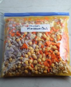 Moroccan Chicken Chili in a freezer bag labeled on counter. This chili with Chickpeas is loaded with comforting and healthy ingredients and spices. You get warmth from Ginger, Turmeric, Garlic, and Coriander. Then tons of hearty flavor from browned ground chicken and Shallots. And creaminess from the Carrots and Chickpeas. You can make it ahead and freeze it until you are ready to cook it!
