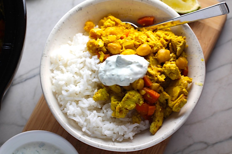Moroccan Chicken Chili in bowl over white rice with a dollop of Cilantro Lime Yogurt on top. Moroccan Chicken Chili with Chickpeas is loaded with comforting and healthy ingredients and spices. You get warmth from Ginger, Turmeric, Garlic, and Coriander. Then tons of hearty flavor from browned ground chicken and Shallots. And creaminess from the Carrots and Chickpeas. You can make it ahead and freeze it until you are ready to cook it!