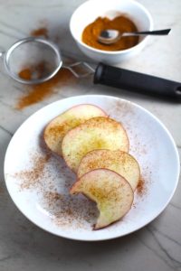 Pumpkin Spice sprinkled on apple slices fanned out on a plate with a bite taken from one slice. Recipe has 4 simple ingredients and takes minutes to make! PLUS, here are 20 EASY WAYS TO USE this Spice blend, many with no baking at all!
