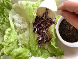 Adding cabbage to Lettuce leaves for Asian Lettuce Wraps. They are a fantastic way to use leftover Turkey or Chicken transforming it with new delicious flavors and textures. The turkey is stir fried with carrots, red pepper, and brussel sprouts in a flavorful ginger, garlic, & sesame sauce. It's layered in lettuce wraps with rice and a cool, crunchy purple cabbage sesame slaw. Serve with a Garlic Honey Soy Sauce....YUM!!!
